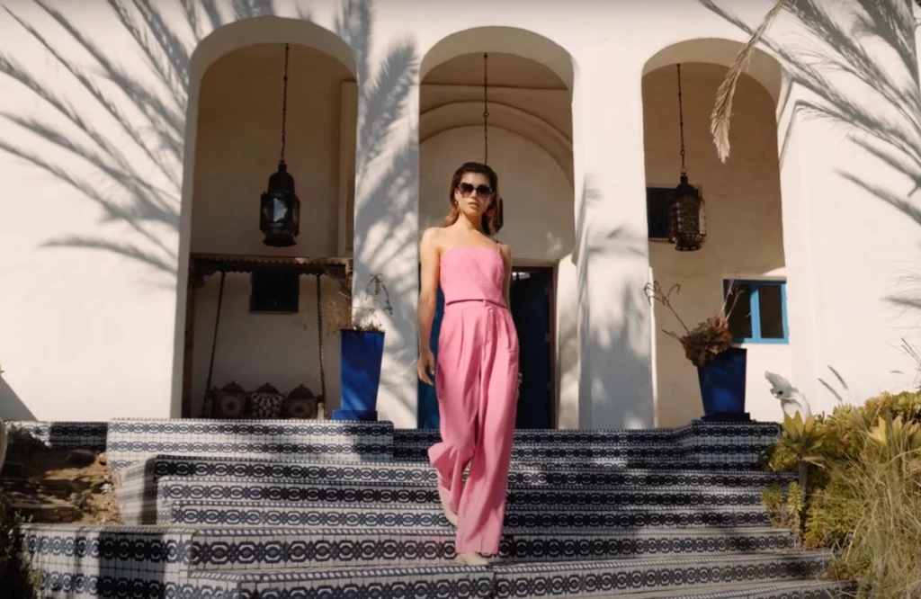 New frame tech poster for video, girl coming down the stairs in pink