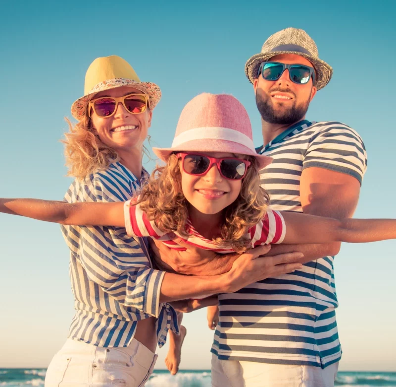 family having fun in the sun wearing sunglasses