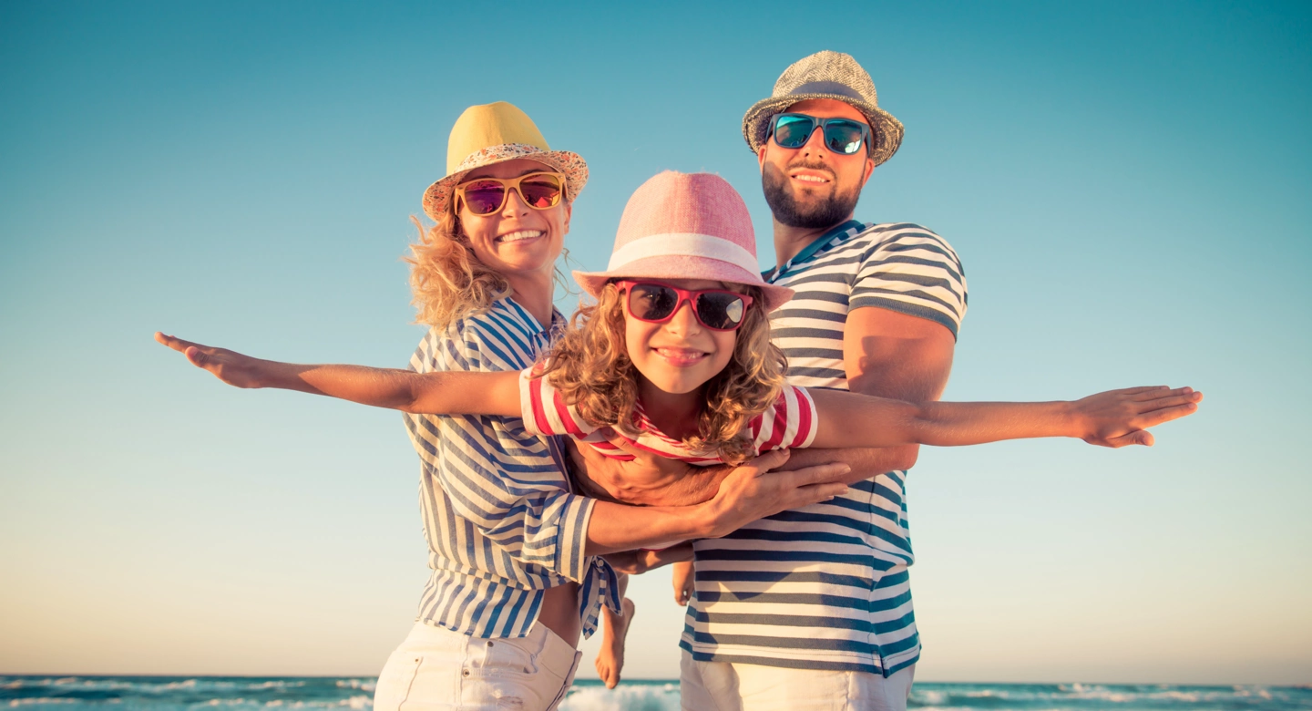 family having fun in the sun wearing sunglasses