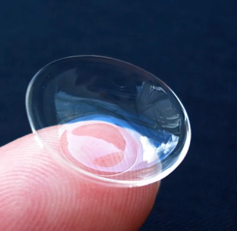 gas permeable contact lens on a finger tip